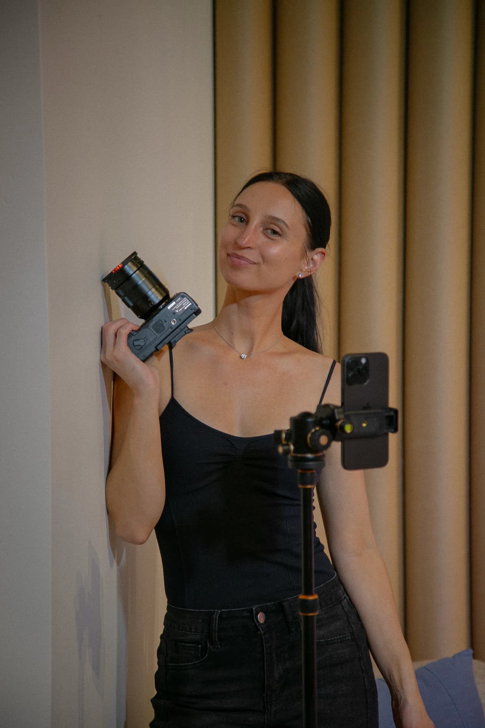 A camera operator holding a camera beside a phone rig